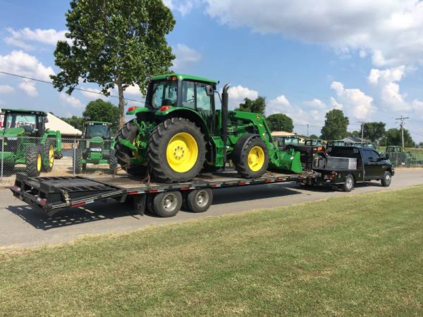 John Deere tractor loaded on a trailer for delivery by J&J Farm Equipment